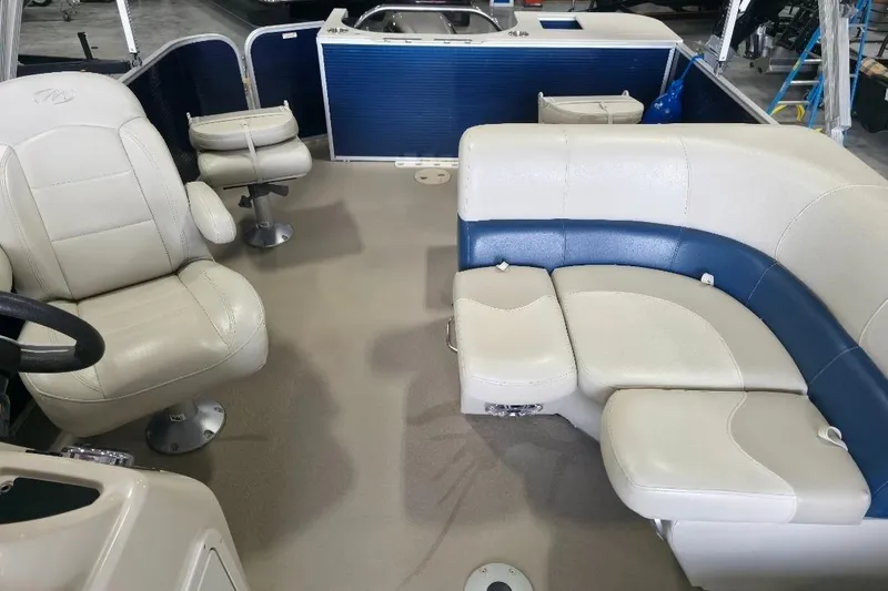 Slide: The Image of 2018 Manitou 22 Aurora LE Angler interior with plush seating and steering area. - 9
