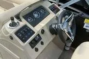 Slide: The Image of 2022 Crest Classic LX 200 boat dashboard with steering wheel and control panel. - 10