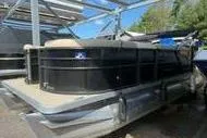 Slide: The Image of 2022 Crest Classic LX 200 pontoon boat docked under a metal canopy. - 4