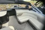 Slide: The Image of 2022 Crest Classic LX 200 boat interior with beige seating and black accents. - 9