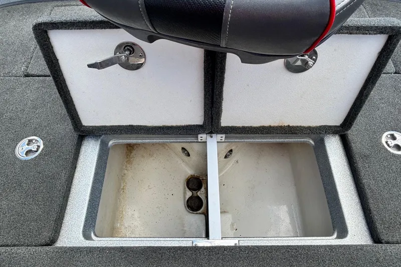 Slide: The Image of 2016 Ranger Z519 Comanche boat storage compartment with open lids and carpeted interior. - 11