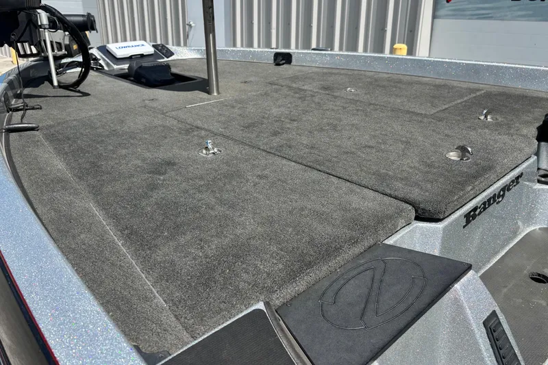 Slide: The Image of 2016 Ranger Z519 Comanche boat deck with carpeted surface and fishing equipment. - 5
