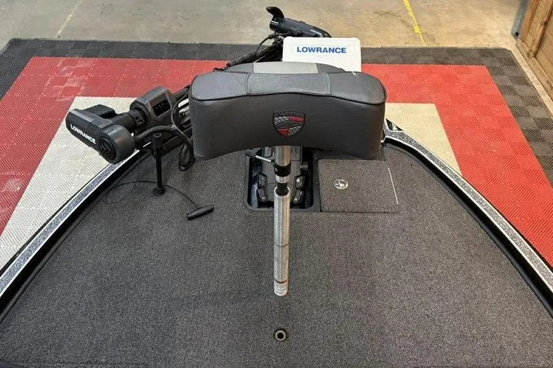 Slide: The Image of 2025 Triton 20XP Patriot boat deck with Lowrance equipment and padded seat. - 10
