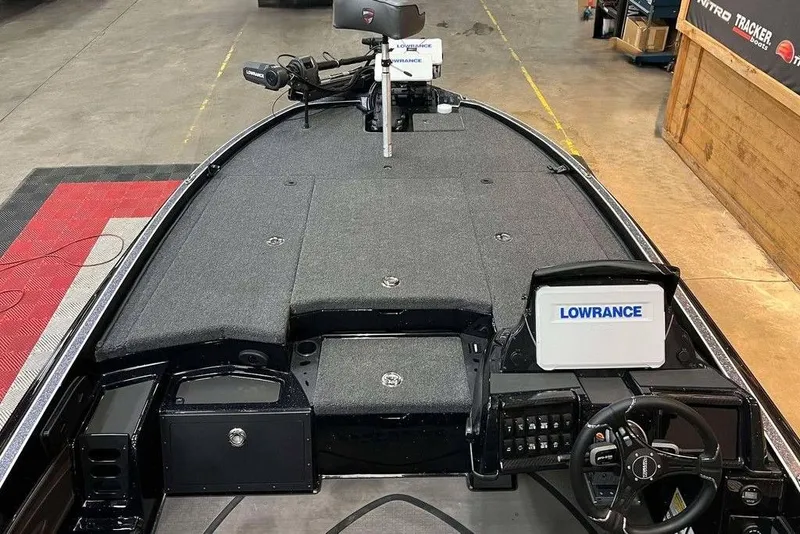 Slide: The Image of 2025 Triton 20XP Patriot boat interior with Lowrance electronics and spacious deck layout. - 11