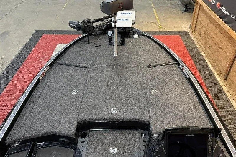 Slide: The Image of 2025 Triton 20XP Patriot boat deck with Lowrance equipment, featuring a spacious layout. - 16