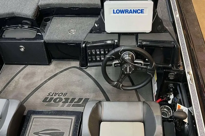 Slide: The Image of Interior of 2025 Triton 20XP Patriot boat with steering wheel and Lowrance display. - 4