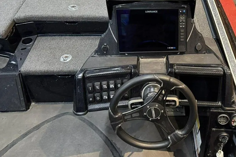Slide: The Image of 2025 Triton 20XP Patriot boat dashboard with steering wheel and Lowrance display. - 5