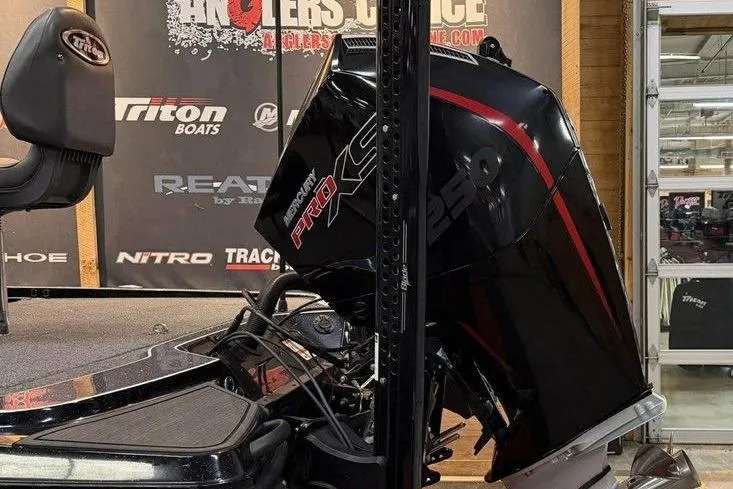 Slide: The Image of 2025 Triton 20XP Patriot boat with Mercury Pro XS 250 engine in showroom. - 6