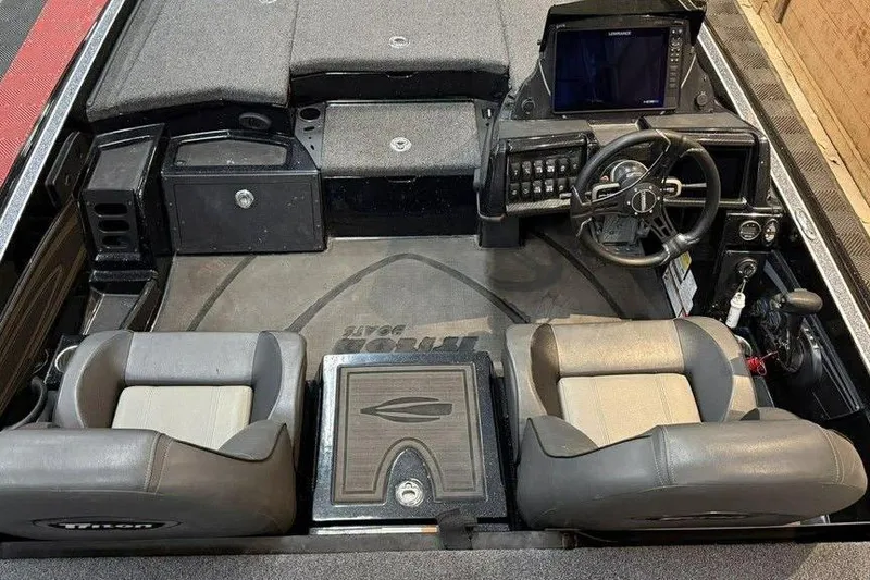 Slide: The Image of Interior of a 2025 Triton 20XP Patriot boat with dual seats and steering console. - 8