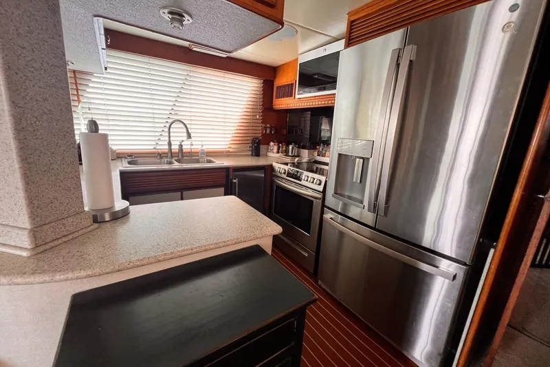 Slide: The Image of Modern kitchen in a 1985 Hartman-Palmer 60 Flush Deck Motor Yacht with stainless steel appliances. - 23