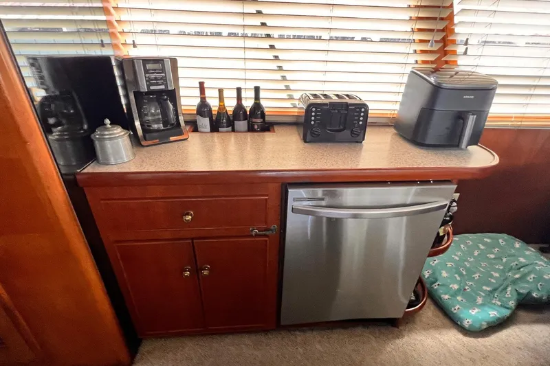 Slide: The Image of Kitchen area on 1985 Hartman-Palmer yacht with appliances and wine bottles. - 26