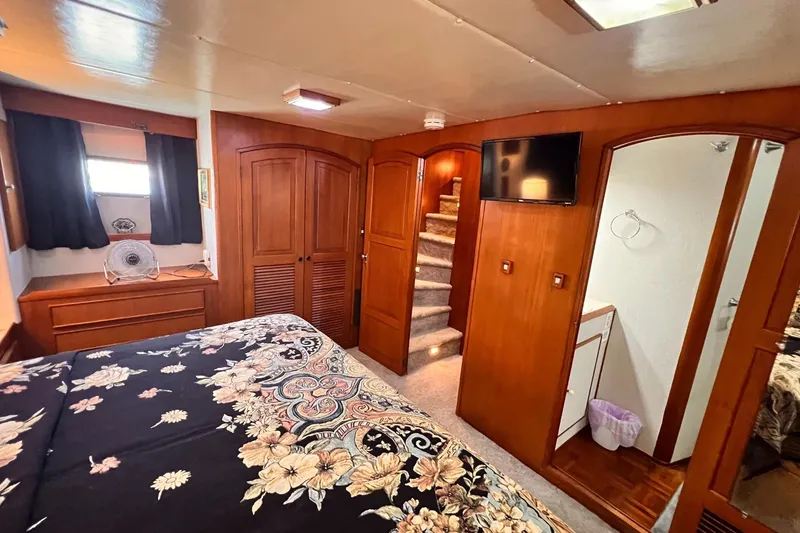 Slide: The Image of Luxurious 1985 Hartman-Palmer 60 Flush Deck Motor Yacht bedroom with elegant wood finishes. - 41