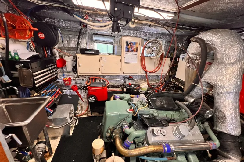 Slide: The Image of Engine room of a 1985 Hartman-Palmer 60 Flush Deck Motor Yacht, featuring tools and equipment. - 59