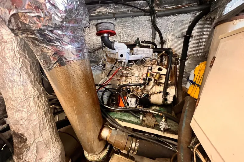 Slide: The Image of Engine room of 1985 Hartman-Palmer 60 Flush Deck Motor Yacht, showing complex machinery and pipes. - 60