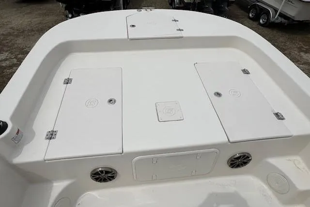 Slide: The Image of 2020 Carolina Skiff 25 LS boat deck with storage compartments and speakers. - 10