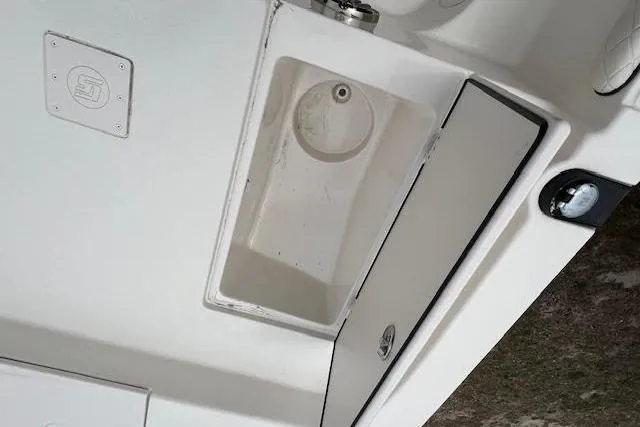 Slide: The Image of 2020 Carolina Skiff 25 LS boat interior with storage compartment and sink. - 11