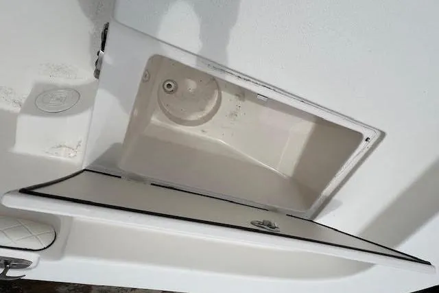 Slide: The Image of Open storage compartment on a 2020 Carolina Skiff 25 LS boat. - 12