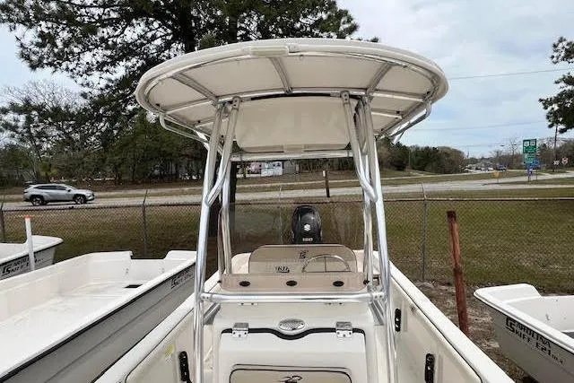 Slide: The Image of 2020 Carolina Skiff 25 LS boat with T-top, parked outdoors near a road. - 14