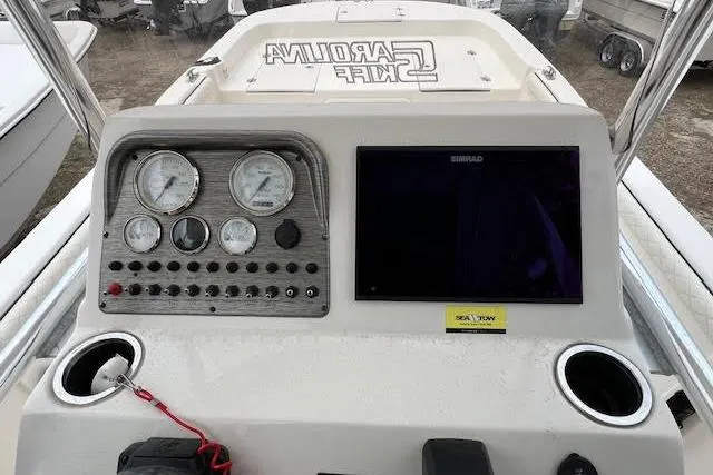 Slide: The Image of 2020 Carolina Skiff 25 LS boat dashboard with gauges and navigation screen. - 16