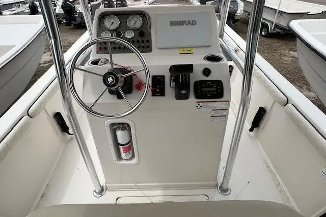 Slide: The Image of 2020 Carolina Skiff 25 LS boat console with steering wheel and navigation controls. - 5