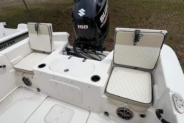 Slide: The Image of 2020 Carolina Skiff 25 LS boat interior with Suzuki 150 engine and cushioned seating. - 6