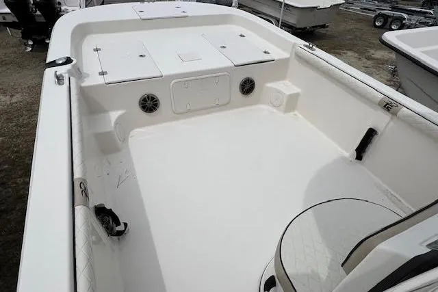 Slide: The Image of 2020 Carolina Skiff 25 LS boat interior, featuring spacious deck and storage compartments. - 9
