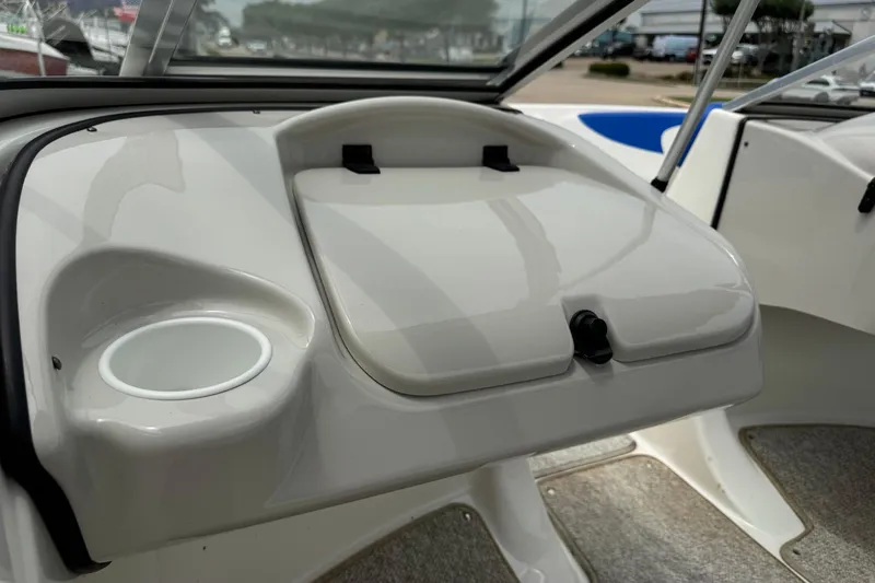 Slide: The Image of Interior of a 2008 Glastron MX 175 boat showing dashboard and cup holder. - 12