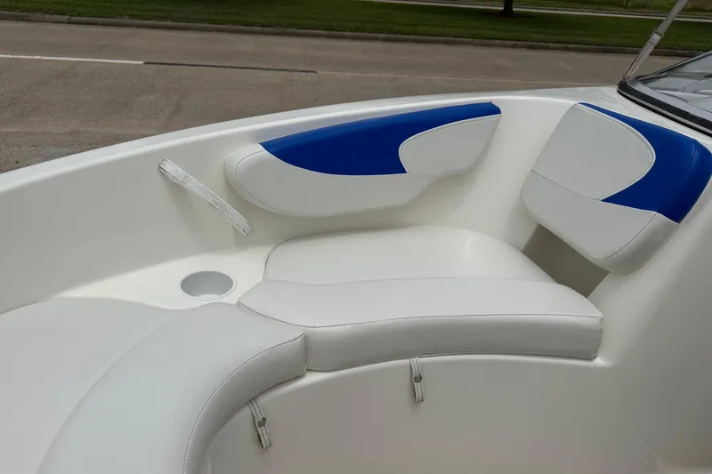 Slide: The Image of 2008 Glastron MX 175 boat interior with white and blue cushioned seating. - 13