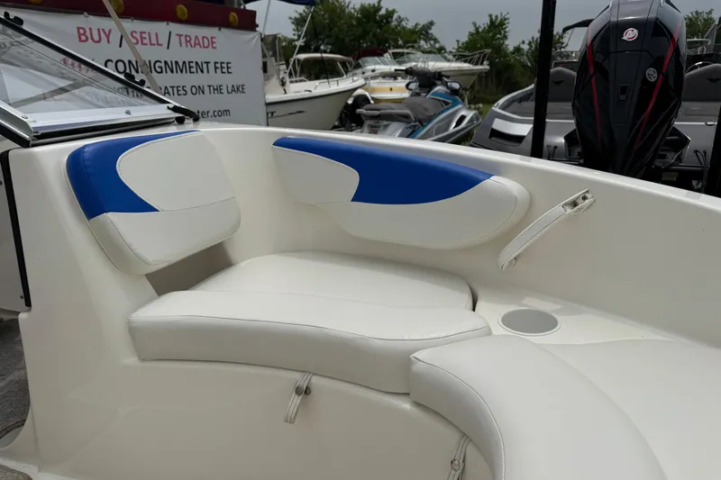 Slide: The Image of Interior seating of a 2008 Glastron MX 175 boat, featuring white and blue upholstery. - 15