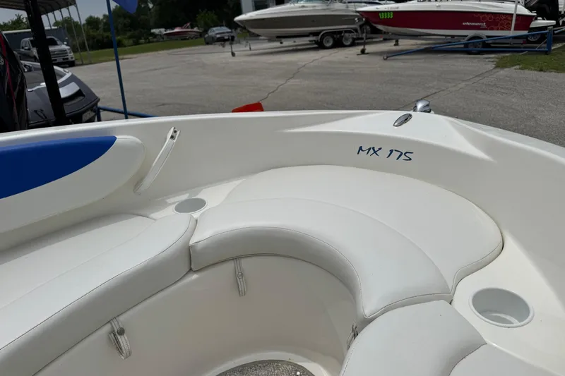 Slide: The Image of 2008 Glastron MX 175 boat interior with white seating and cup holder. - 17