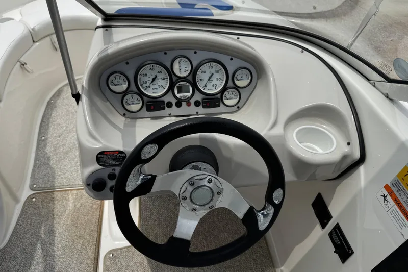 Slide: The Image of 2008 Glastron MX 175 boat dashboard with steering wheel and instrument gauges. - 18