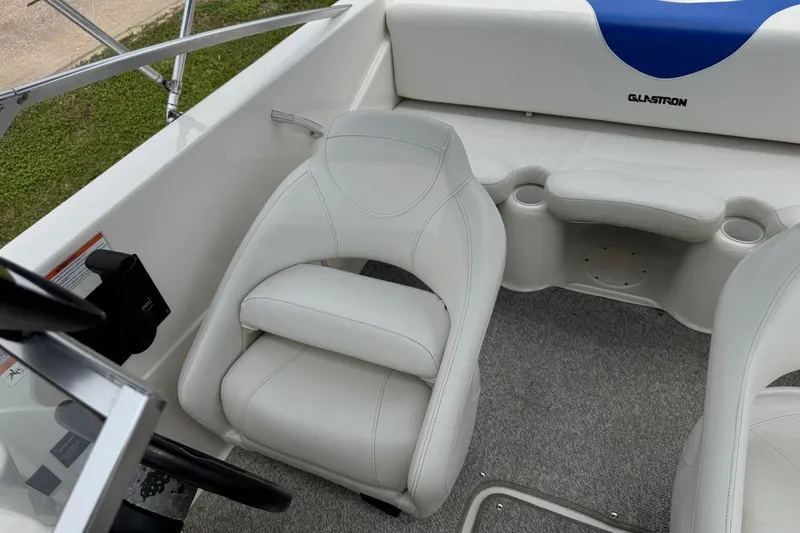 Slide: The Image of 2008 Glastron MX 175 boat interior with white seating and steering wheel. - 21