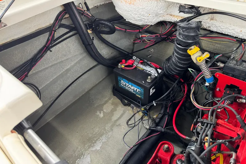 Slide: The Image of 2008 Glastron MX 175 boat engine compartment with battery and wiring. - 24