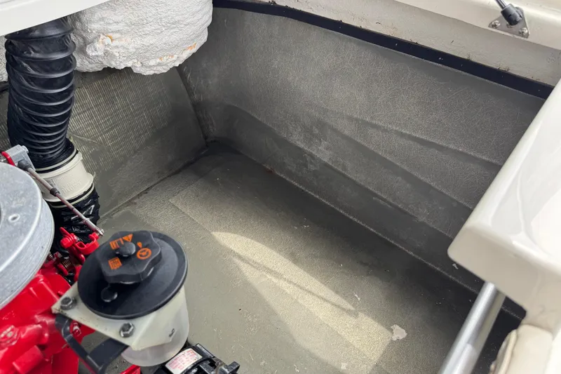 Slide: The Image of Engine compartment of a 2008 Glastron MX 175 boat, showing mechanical components. - 25