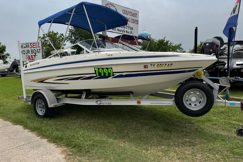Slide: The Image of 2008 Glastron MX 175 boat on trailer with blue canopy, priced at $7999. - 3