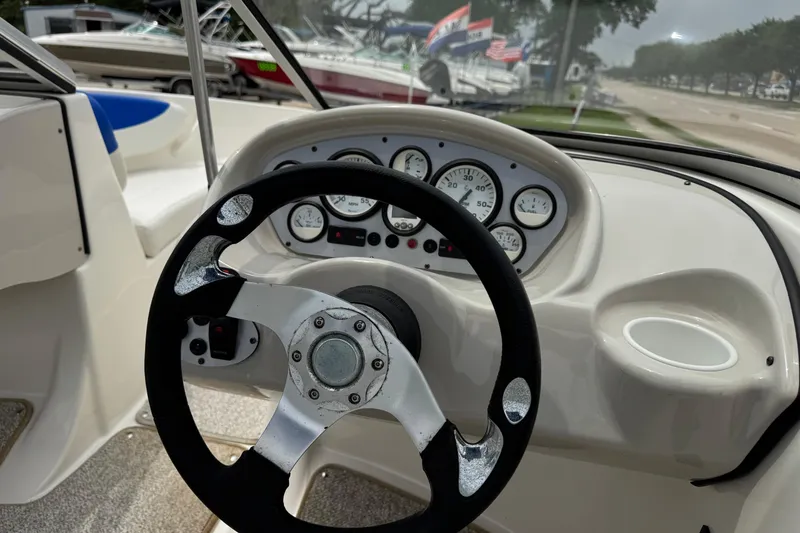 Slide: The Image of 2008 Glastron MX 175 boat dashboard with steering wheel and gauges. - 5