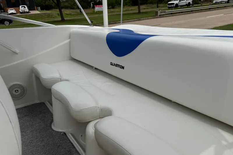 Slide: The Image of 2008 Glastron MX 175 boat interior with white seating and blue accents. - 7