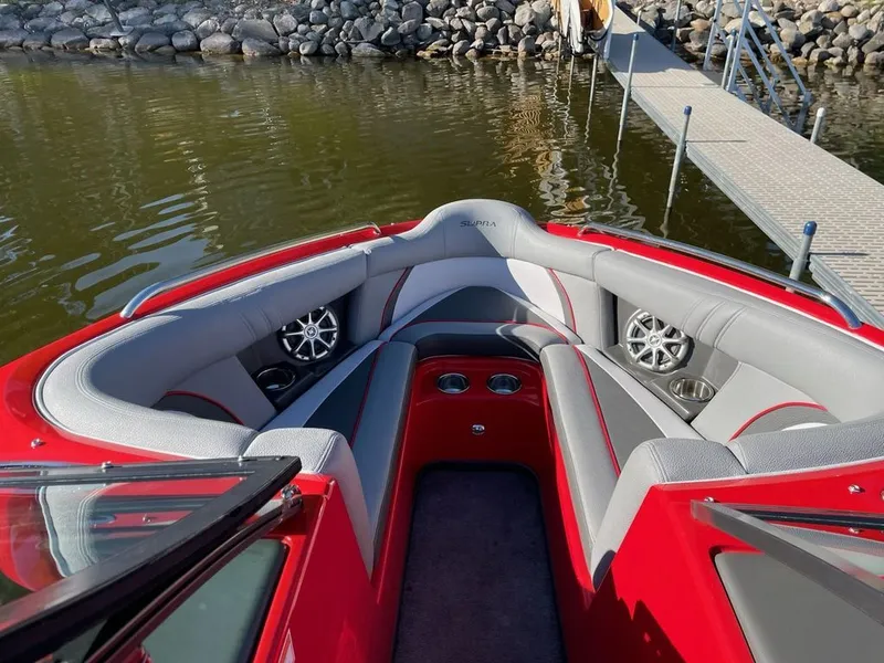 Slide: The Image of 2011 Supra Sunsport boat with luxurious interior at the dock. - 2