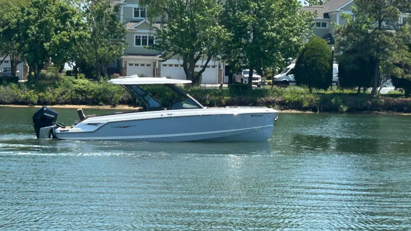 Slide: The Image of 2025 Monterey Elite 30 OB boat on calm water. - 1