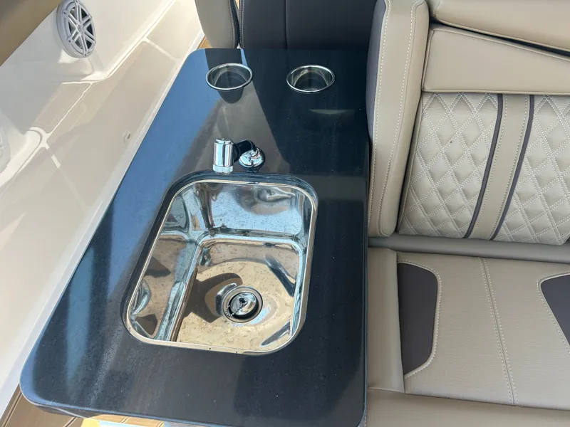 Slide: The Image of Monterey Elite 30 OB 2025 boat with sink and cup holders. - 16