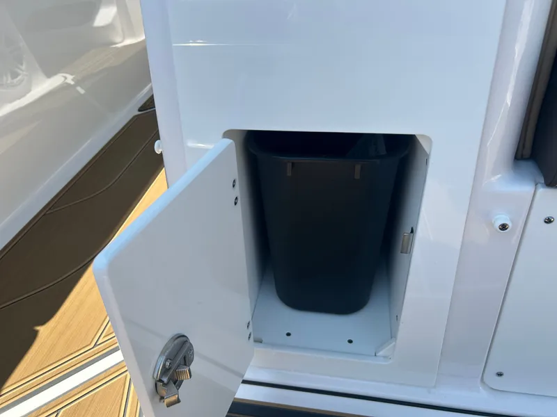Slide: The Image of Trash compartment in 2025 Monterey Elite 30 OB boat. - 17
