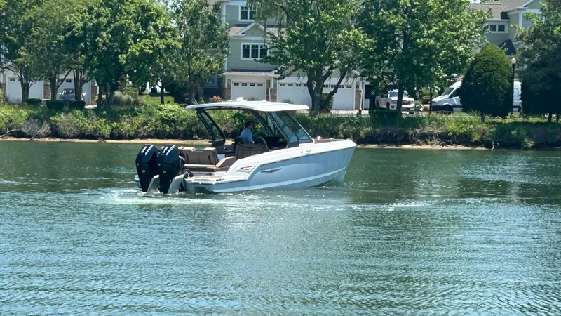 Slide: The Image of 2025 Monterey Elite 30 OB boat on calm water. - 2