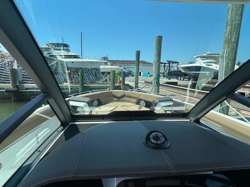 Slide: The Image of Interior view of 2025 Monterey Elite 30 OB at a marina. - 25