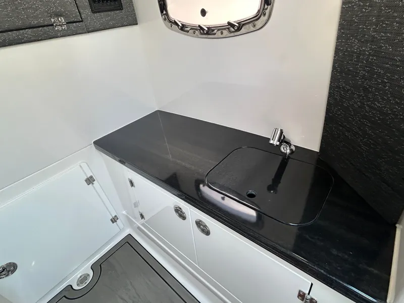 Slide: The Image of Interior of 2025 Monterey Elite 30 OB with sink and storage. - 28