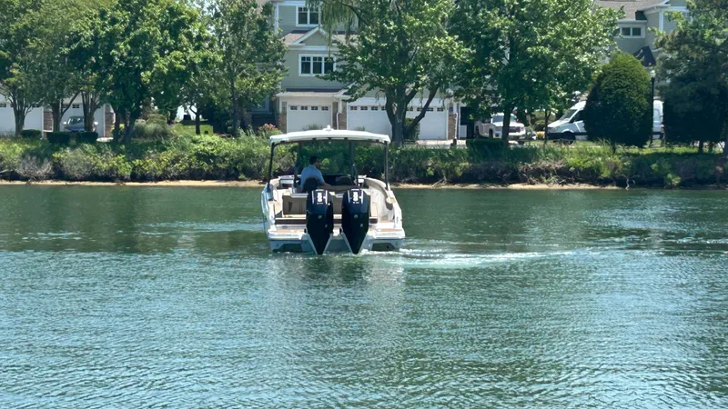 Slide: The Image of 2025 Monterey Elite 30 OB boat on calm water. - 3