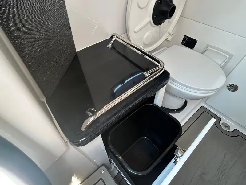 Slide: The Image of Interior of 2025 Monterey Elite 30 OB with toilet and storage. - 30