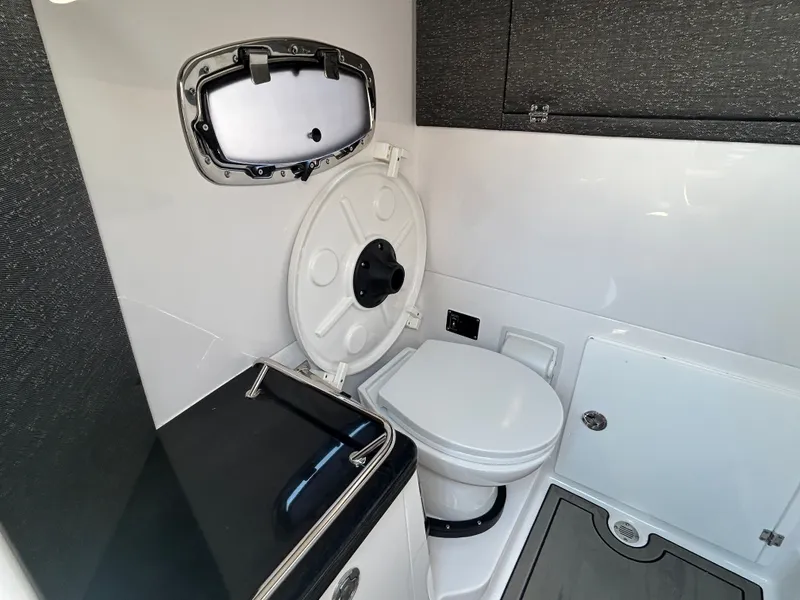 Slide: The Image of Interior of 2025 Monterey Elite 30 OB featuring toilet and window. - 31