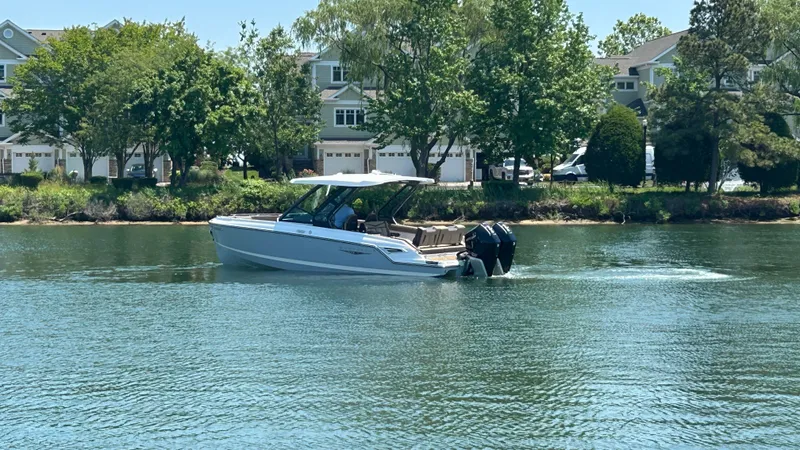 Slide: The Image of 2025 Monterey Elite 30 OB boat on calm water. - 4