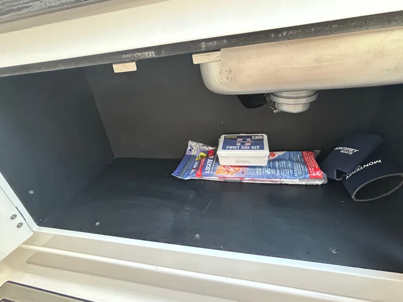 Slide: The Image of Storage compartment in 2025 Monterey Elite 30 OB with first aid kit. - 41