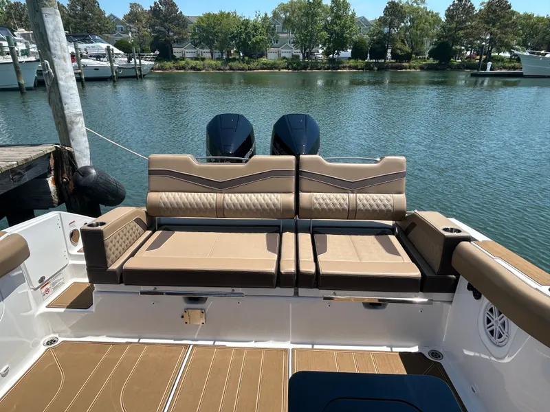 Slide: The Image of 2025 Monterey Elite 30 OB with luxurious seating by the water. - 9